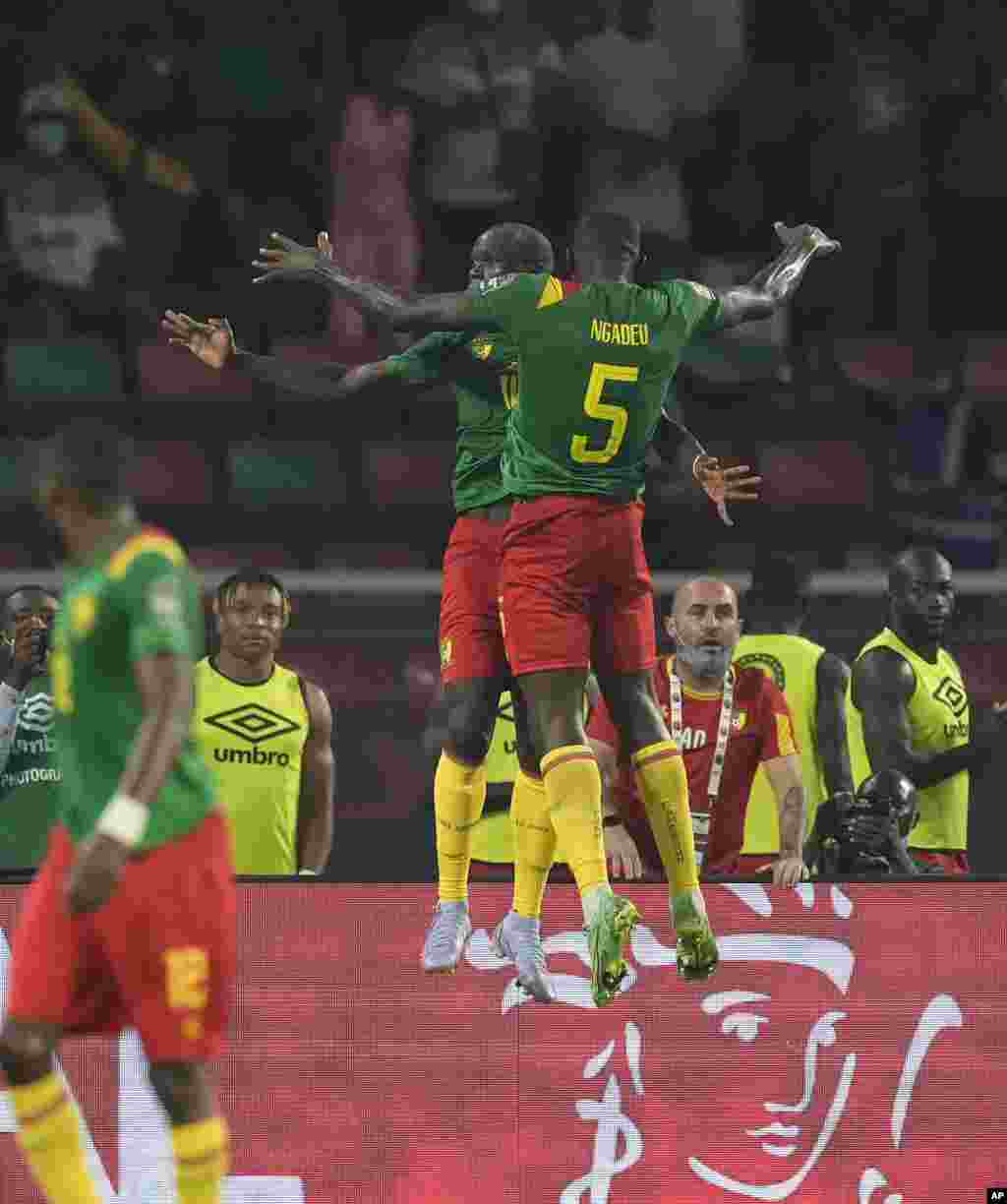 Cameroon's Vincent Aboubakar, rear, with teammate Michael Ngadeu-Ngadjui celebrates scoring his side's second goal during the round of 16 soccer match against Comoros in Yaounde, Cameroon, Jan. 24, 2022.