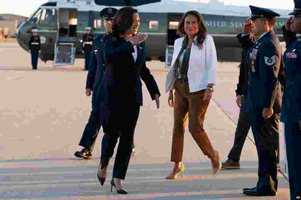 Vice President Kamala Harris, left, with Rep. Veronica Escobar, D-Texas, salutes as they board Air Force Two, June 25, 2021, at Andrews Air Force Base, Md., en route to El Paso, Texas.