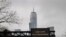 One World Trade is seen behind a sign that flashes an emergency alert, as the coronavirus disease (COVID-19) outbreak continues in New York City, New York.