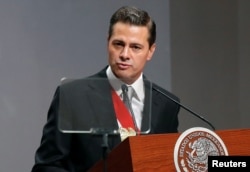 FILE - Mexico's President Enrique Pena Nieto delivers his sixth and last State of the Union address at the National Palace in Mexico City, Mexico, Sept. 3, 2018.