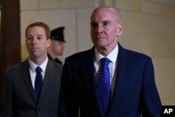 Michael McKinley, right, the top aide to Secretary of State Mike Pompeo, arrives testify at a closed-door deposition on Capitol Hill in Washington, Oct. 16, 2019.