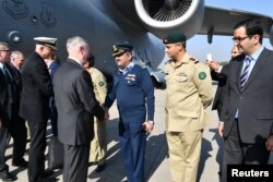 FILE - A handout from the US Embassy shows US Defense Secretary Jim Mattis being greeted by Pakistani military officials as he arrives in Islamabad, Pakistan, Dec. 4, 2017.