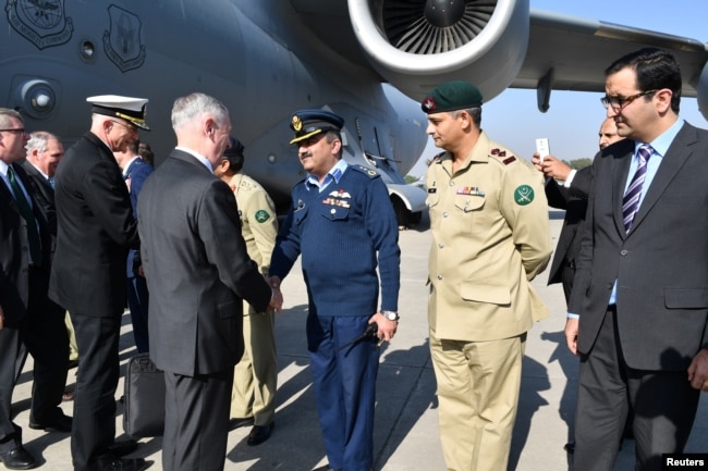 FILE - A handout from the US Embassy shows US Defense Secretary Jim Mattis being greeted by Pakistani military officials as he arrives in Islamabad, Pakistan, Dec. 4, 2017.