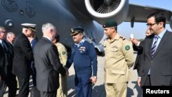 FILE - U.S. Defense Secretary Jim Mattis is greeted by Pakistani military officials as he arrives in Islamabad, Pakistan, Dec. 4, 2017. 