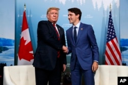 President Donald Trump, left, meets with Canadian Prime Minister Justin Trudeau during the G-7 summit, June 8, 2018, in Charlevoix, Canada.