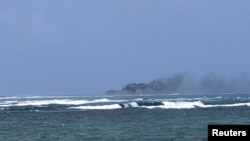 A view of a New Zealand Navy vessel on fire, as seen from Tafitoala, Samoa, Oct. 6, 2024, in this picture obtained from social media. (Dave Poole/via Reuters)