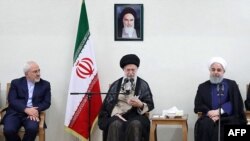 FILE - A handout picture provided by the office of Iran's Supreme Leader Ayatollah Ali Khamenei July 15, 2018, shows Khamenei (C) sitting between President Hassan Rouhani (R) and Foreign Minister Mohammad Javad Zarif (L) during a meeting in Tehran.