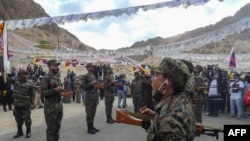FILE - Indian soldiers pay their respects during the funeral of their comrade, Tibetan-origin India's special forces soldier Nyima Tenzin, in Leh, Sept. 7, 2020.