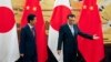 Japanese Prime Minister Shinzo Abe, left, and Chinese Premier Li Keqiang prepare to leave after attending a signing ceremony at the Great Hall of the People in Beijing, Oct. 26, 2018.