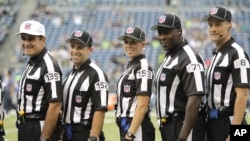FILE - Sarah Thomas (C), who has worked exhibition games, is seen with male NFL officials in an Aug. 15, 2014, photo.