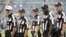 FILE - Sarah Thomas (C), who has worked exhibition games, is seen with male NFL officials in an Aug. 15, 2014, photo.