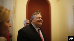 Socialist leader Evangelos Venizelos, walks inside the Parliament building after meeting with Greece's conservative election victor Antonis Samaras in Athens Monday, June 18 2012. 