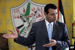 FILE - Palestinian Fatah leader Mohammed Dahlan gestures as he speaks during an interview with The Associated Press in his office in the West Bank city of Ramallah, Jan. 3, 2011.