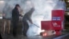 First responders pull out the burning contents of a ballot box after it was set on fire in a suspected arson in Vancouver, Washington, Oct. 28, 2024, in a still image from video. (Evan Bell/ABC Affiliate KATU via Reuters)