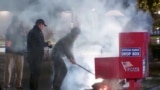 First responders pull out the burning contents of a ballot box after it was set on fire in a suspected arson in Vancouver, Washington, Oct. 28, 2024 in a still image from video. (Evan Bell/ABC Affiliate KATU via Reuters)