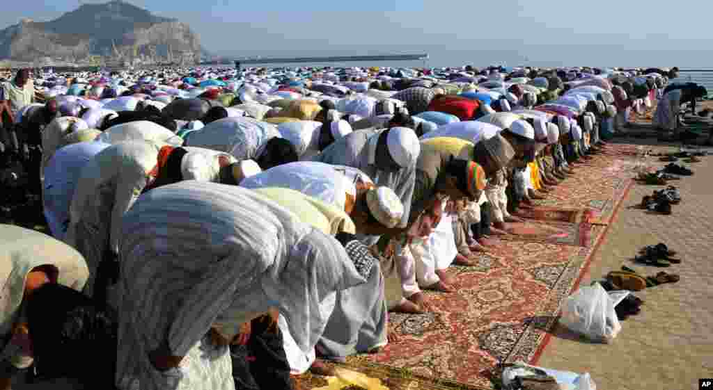 Muslims pray during Eid al-Fitr prayer, which marks the end of the holy month of Ramadan, in Palermo, Italy, August, 19, 2012.