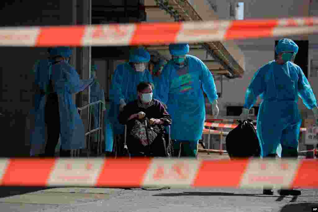 A resident of The Salvation Army Lung Hang Residence for Senior Citizens is evacuated by medical staff from the Centre for Health Protection, after employees of the nursing home were found to have the coronavirus, in Hong Kong. 