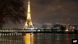 A flooded street lamp and signboards are pictured next to the river Seine in Parison the river Seine in Paris, Jan. 27, 2018. 