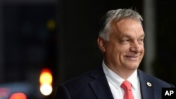 Hungary's Prime Minister Viktor Orban leaves the EU Council building during an EU summit in Brussels, where he touted what he called his victory at the European Union summit, July 20, 2020.