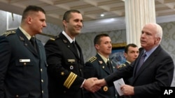 U.S. Sen. John McCain (right) shakes hand with Montenegrin army officers in Podgorica, Montenegro, April 12, 2017. McCain has congratulated Montenegro for its upcoming NATO membership, blasting Russia for its attempts to interfere in the Balkans.