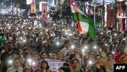 Activists and medical professionals shout slogans during a protest march to condemn the rape and murder of a doctor in Kolkata on October 1, 2024.