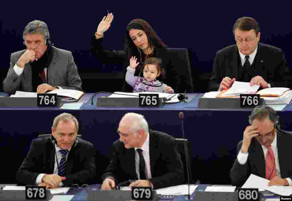 Italy's Member of the European Parliament Licia Ronzulli takes part with her daughter in a voting session at the European Parliament in Strasbourg February 15, 2012. (Reuters)