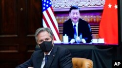 FILE - Secretary of State Antony Blinken listens during a virtual meeting with Chinese President Xi Jinping, from the Roosevelt Room of the White House in Washington, Nov. 15, 2021. 