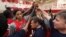 Head coach Geno Auriemma, center, joins Candace Parker, left, and the rest of the US women's basketball Olympic team in a huddle as they complete practice Friday, May 11, 2012, in Seattle.