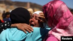 A woman reacts during the funeral of two victims of the deadly earthquake, in Moulay Brahim, Morocco, September 10, 2023. 