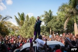 Robert Kyagulanyi delivers a speech outside his home in Kampala, Uganda, after returning from the United States, Sept. 20, 2018.