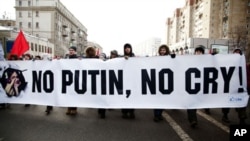 Protesters walk with anti-Putin banner in mass opposition march in central Moscow, Feb. 4, 2012.