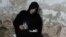 Palestinian Nadia Abu Nada holds a picture of her son Ihab Abu Nada, who set himself on fire because he could not find a job, in Gaza City, September 3, 2012.  