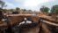 A man is seen inside a burnt house during clashes between nomads and residents in Deleij village, central Darfur, Sudan, June 11, 2019. 