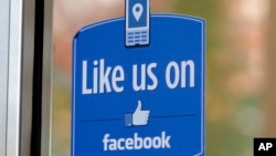 FILE - In this Dec. 13, 2011 file photo, a sign with Facebook's "Like" logo is posted at Facebook headquarters near the office for the company's User Operations Safety Team in Menlo Park, Calif. 
