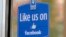 FILE - A sign with Facebook's "Like" logo is posted at Facebook headquarters in Menlo Park, California. 