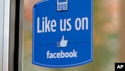 FILE - A sign with Facebook's "Like" logo is posted at Facebook headquarters in Menlo Park, California, Dec. 13, 2011. 