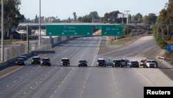 FILE - California Highway Patrol police cars block the highway leading from Mexico into San Diego after the border between Mexico and the U.S. was temporarily closed in the San Ysidro neighborhood of San Diego, California, Nov. 25, 2018.