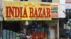 Commuters on a scooter ride past a shop whose name was changed from 'China Bazar' to 'India Bazar' in Hyderabad on September 10, 2020. - In India there have been growing calls for a boycott of Chinese goods amid a backlash after a deadly border…