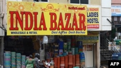 Commuters on a scooter ride past a shop whose name was changed from 'China Bazar' to 'India Bazar' in Hyderabad, India, on Sept. 10, 2020.