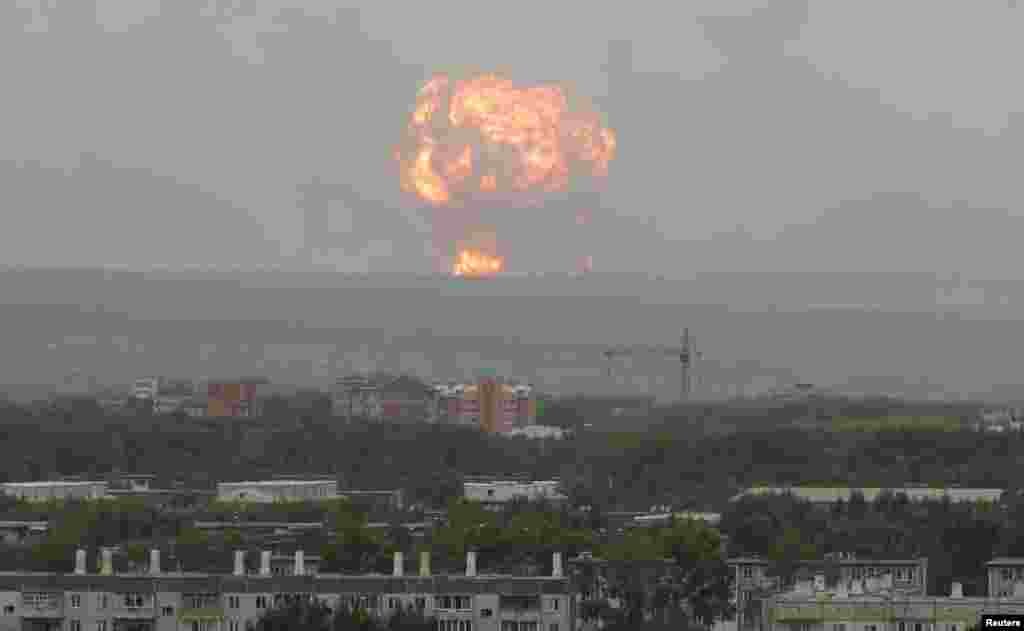 Flame and smoke rise from the site of blasts at an ammunition depot near the town of Achinsk in Krasnoyarsk region, Russia.