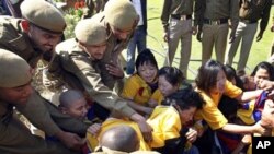 Tibetan exiles scuffle with Indian Police at a protest outside the Chinese Embassy on the eve of the anniversary of the Tibetan Uprising in 1959, in New Delhi, India, Wednesday,