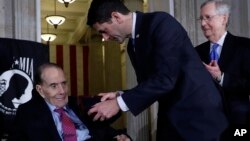 House Speaker Paul Ryan of Wisconsin, presents the Congressional Gold Medal to former Sen. Bob Dole on Capitol Hill, Jan. 17, 2018, in Washington, as Senate Majority Leader Mitch McConnell, watches. 