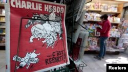 FILE - The front page of satirical French weekly Charlie Hebdo entitled "C'est Reparti" ("Here we go again"), is displayed at a kiosk in Nice, France. 