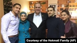 U.S. Rep. Dan Kildee of Michigan meets with former Iran prisoner Amir Hekmati, second from right, at Landstuhl Regional Medical Center in Landstuhl, Germany. Hekmati's family members are with them.