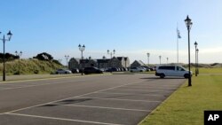FILE - A sparsely filled parking lot is seen at the Trump International golf course in Balmedie, Scotland, Oct. 6, 2017.