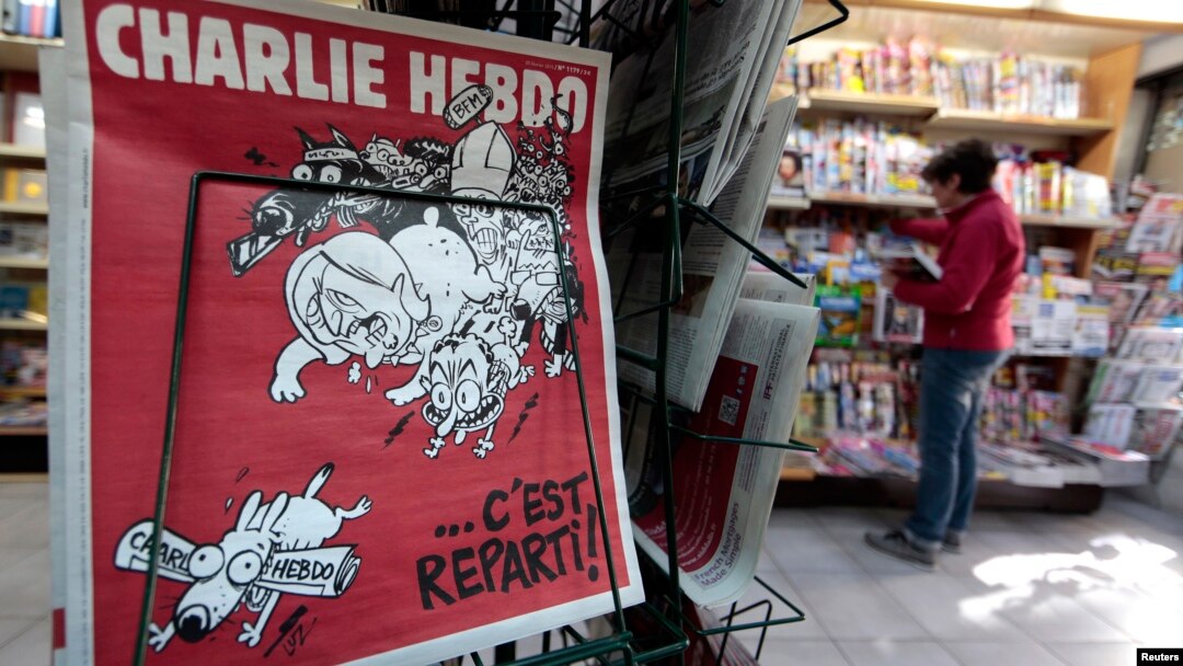 The front page of the new issue of satirical French weekly Charlie Hebdo entitled "C'est Reparti" ("Here we go again"), is displayed at a kiosk in Nice, Feb. 25, 2015. 