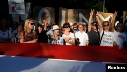 FILE - People are seen gathered during an anti-government protest in support of a free judiciary in front of the Senate building in Warsaw, Poland, July 24, 2018.