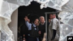 FILE - Israel's President Isaac Herzog, center left, and German President Frank-Walter Steinmeier, center right, visit Kibbutz Beeri in southern Israel, Nov. 27, 2023.