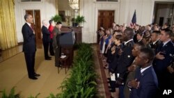 President Barack Obama says the Pledge of Allegiance during a naturalization ceremony for active duty service members in the East Room of the White House in Washington, Wednesday, July 4, 2012. (AP Photo/Evan Vucci)