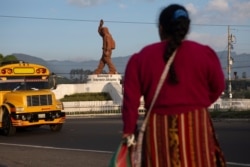 A Quiche indigenous woman faces a monument that pays homage to migrants from the town of Salcaja, at the entrance to the town in Guatemala, June 7, 2019. Central Americans still dream of reaching the United States as Mexico cracks down on migration.